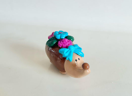Sculpted hedgehog figurine with flowers