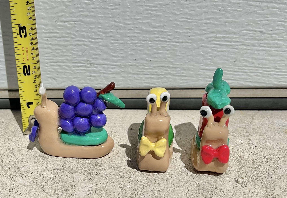 Fruit clay snail figurines