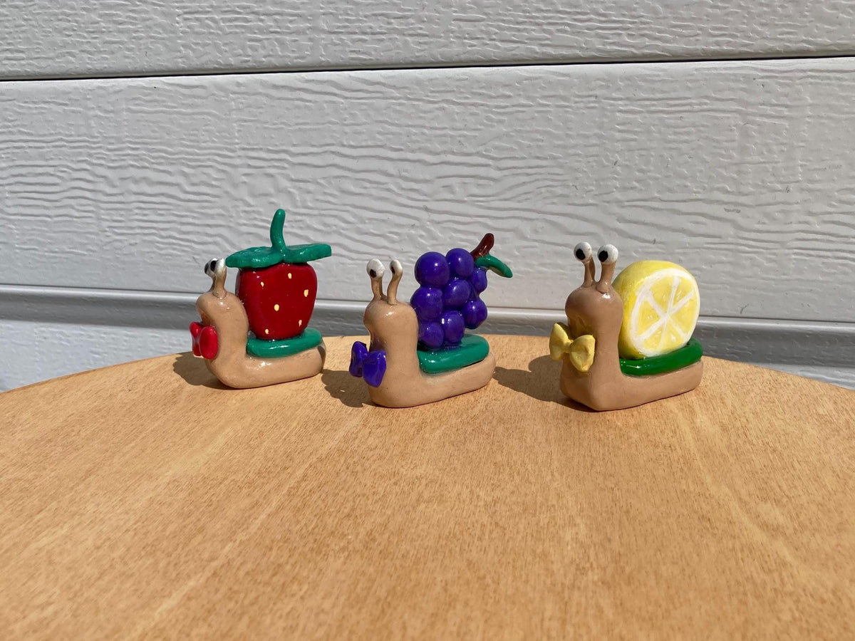 Fruit clay snail figurines