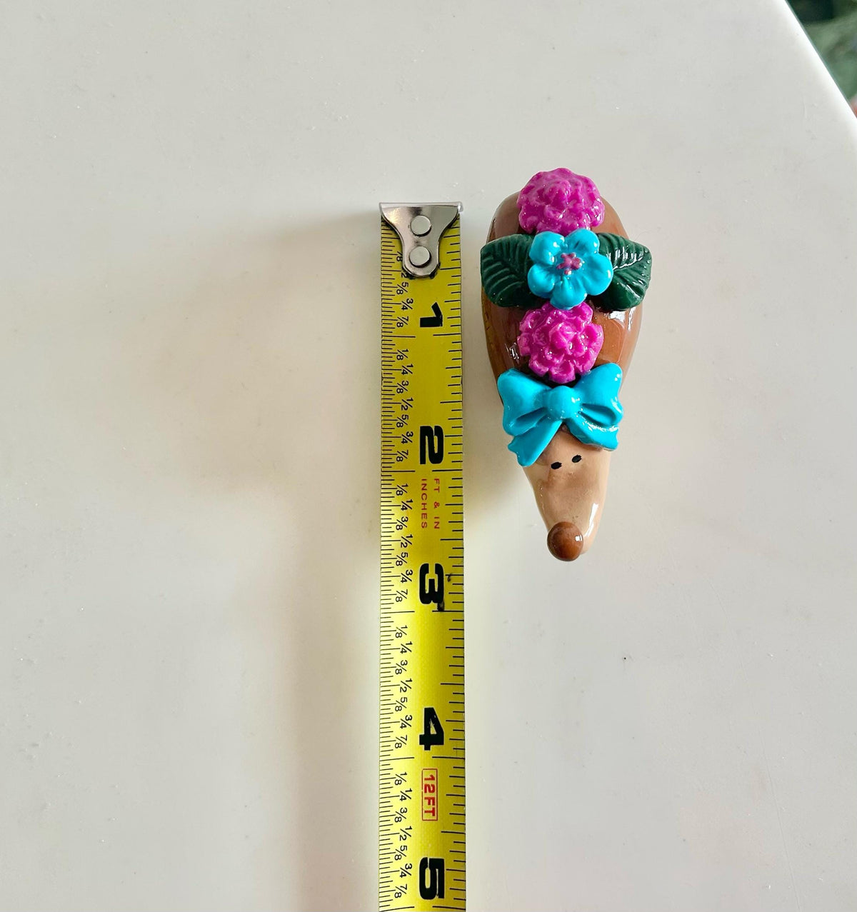 Sculpted hedgehog figurine with flowers