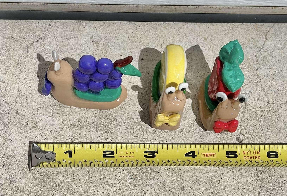 Fruit clay snail figurines