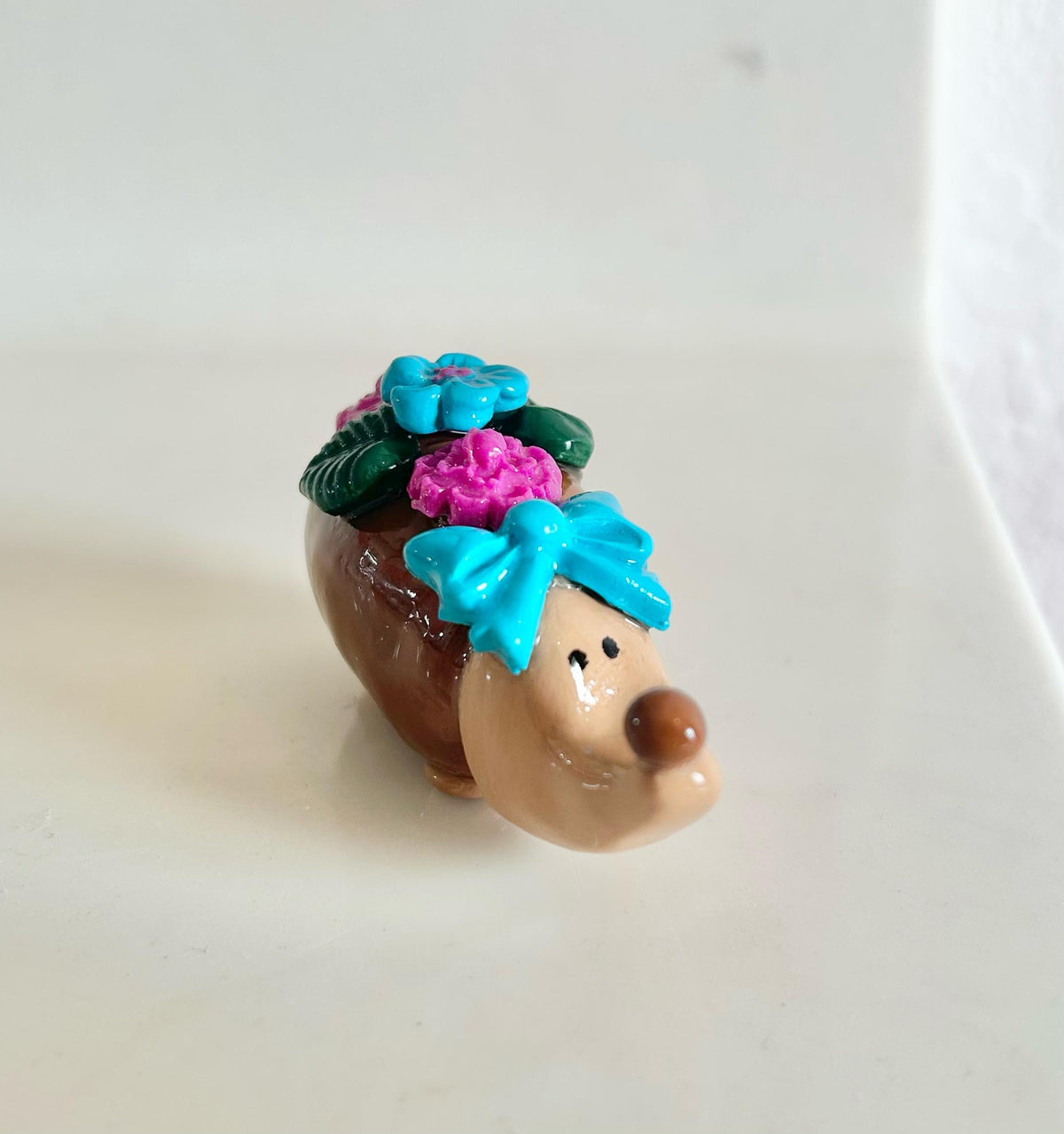 Sculpted hedgehog figurine with flowers
