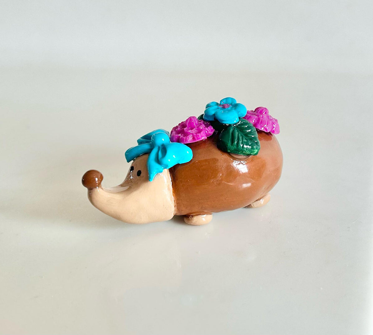 Sculpted hedgehog figurine with flowers