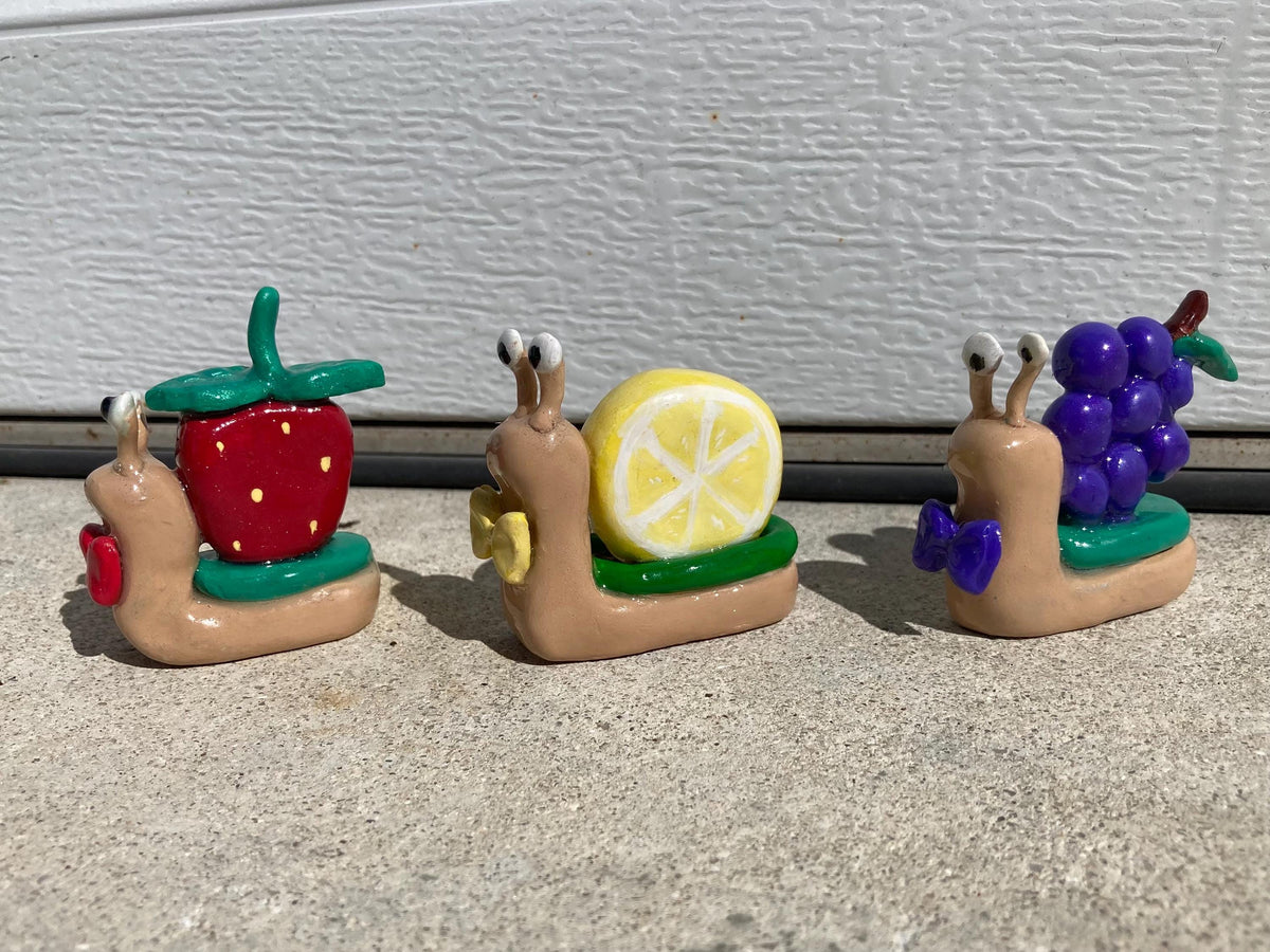 Fruit clay snail figurines
