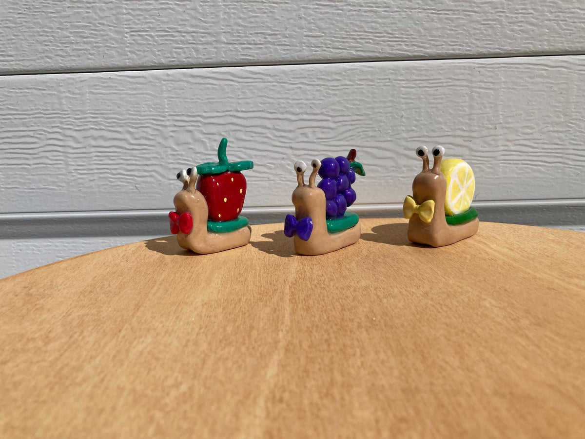 Fruit clay snail figurines
