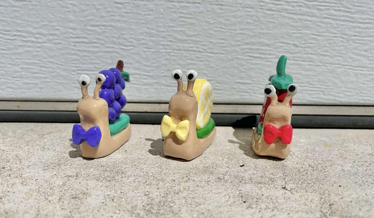 Fruit clay snail figurines
